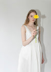 Róhe Sculptural Textured Cotton Dress in Off White. Long, v-neck dress with low back and gathered skirt. 