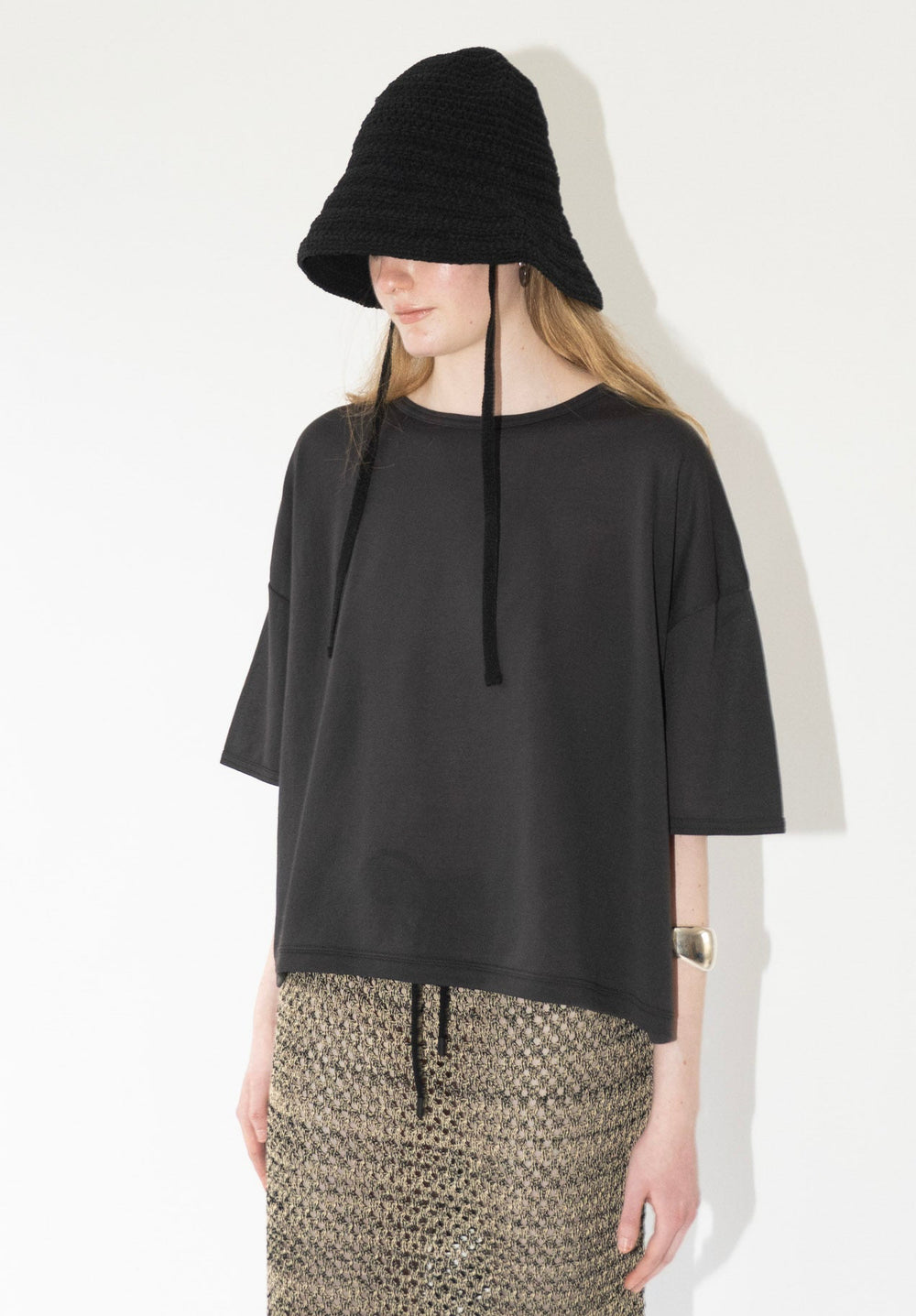 Sheer Fleece Cropped Tee in Charcoal from Chimala. This tee has a wide cropped fit, with a slight box shape, that features a draped silhouette.