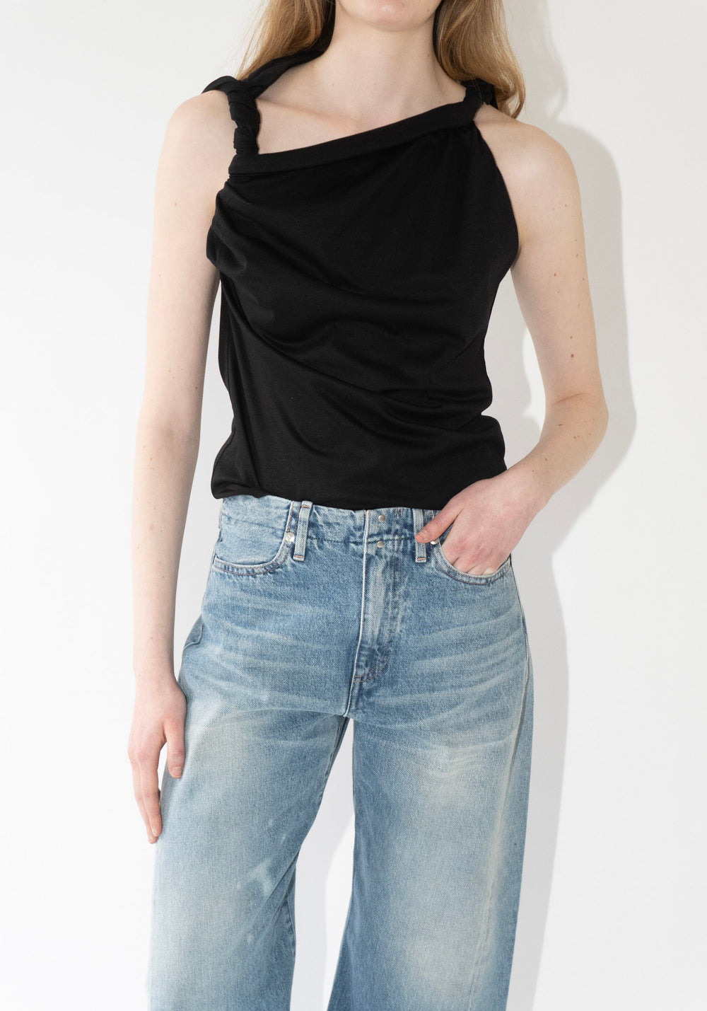 Róhe Sculptural Cotton Silk Top in Black. A drapey top in a cotton-silk blend, defined by twisted strap details and a soft asymmetry as one sleeve falls off the shoulder, creating a relaxed, sculptural silhouette.