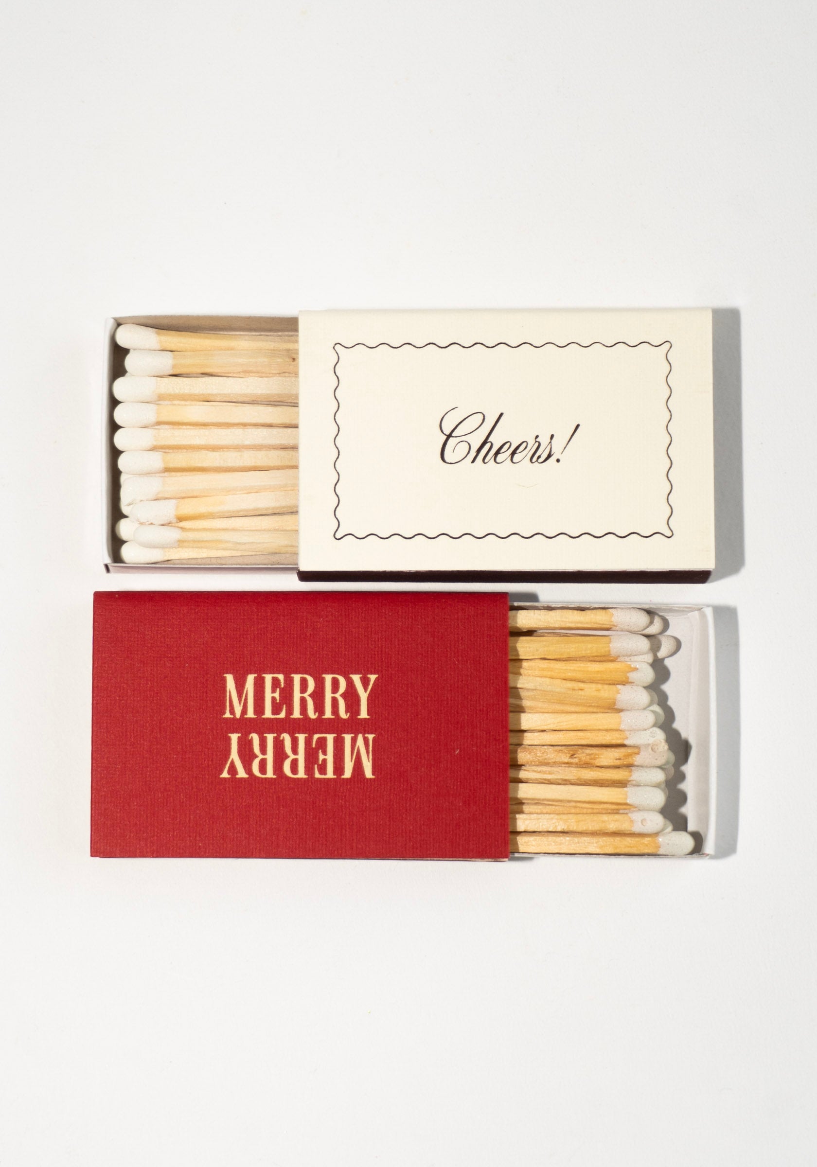 Matches with a red box labeled 'Merry' and a white box labeled 'Cheers!' on a white background