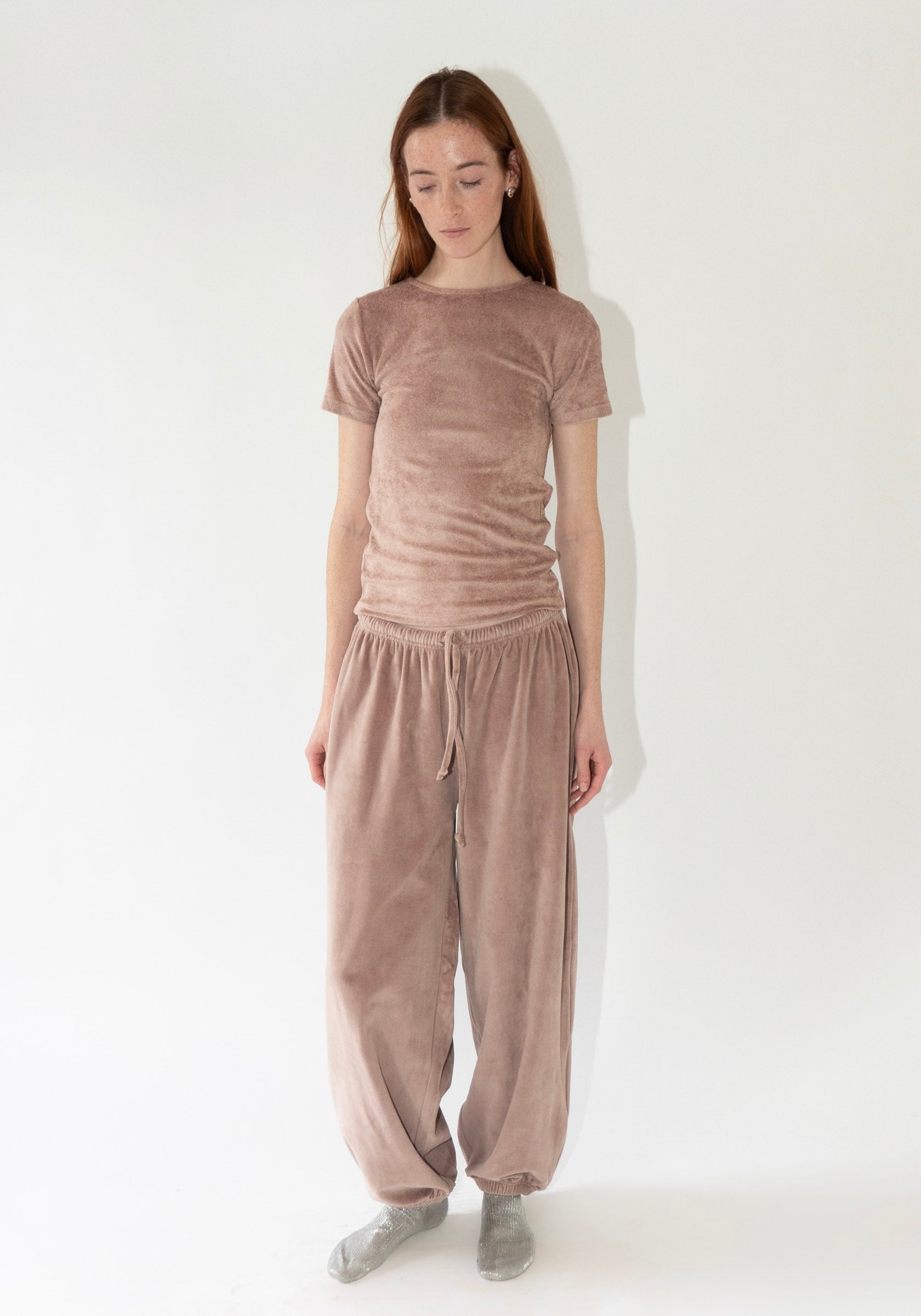 Pillow Sweatpants in Tecto Brown from Baserange. Organic cotton velour pants with an elastic waistband and cuffs. Features a drawstring waistband.