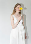 Róhe Sculptural Textured Cotton Dress in Off White. Long, v-neck dress with low back and gathered skirt. 
