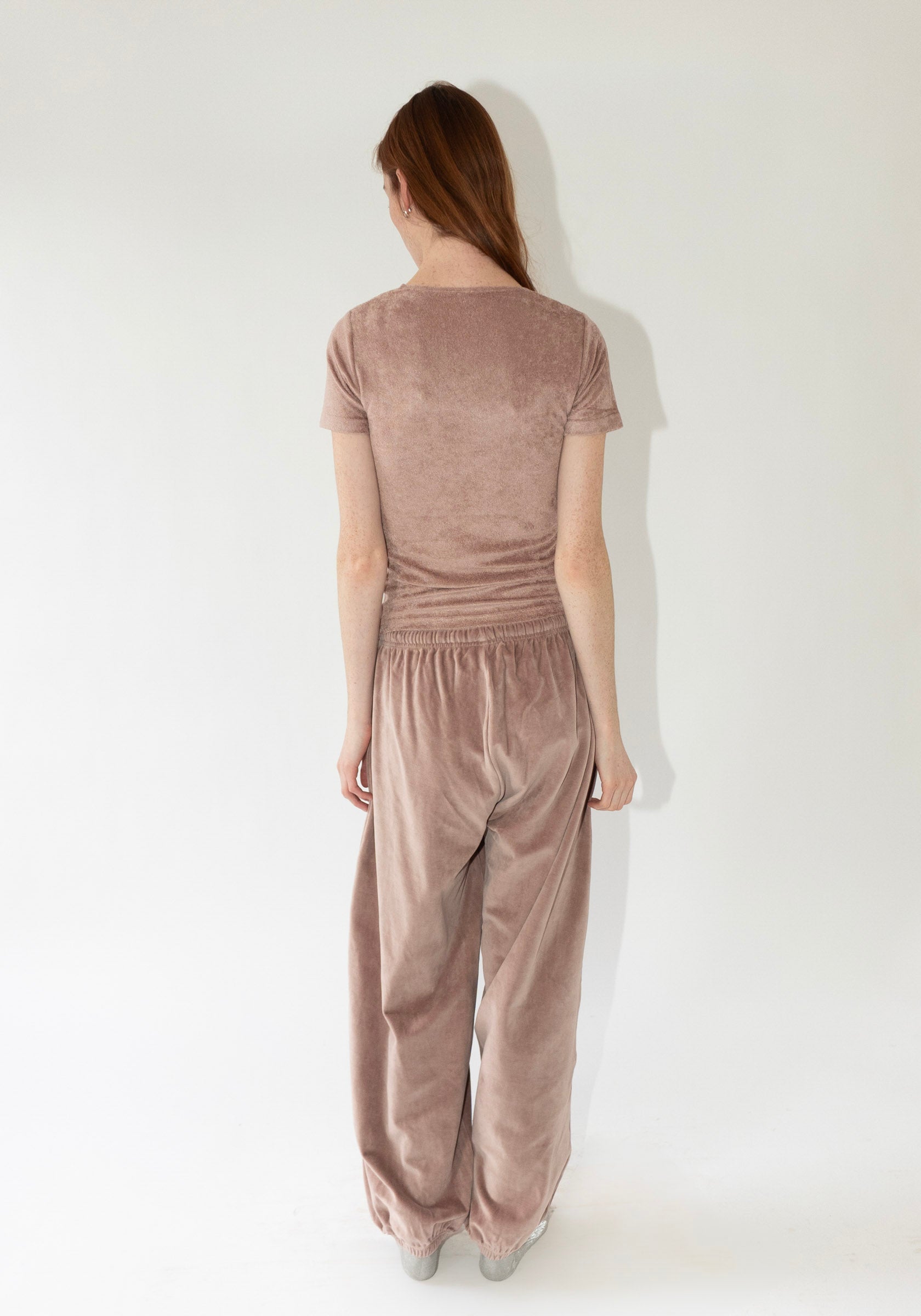 Pillow Sweatpants in Tecto Brown from Baserange. Organic cotton velour pants with an elastic waistband and cuffs. Features a drawstring waistband.