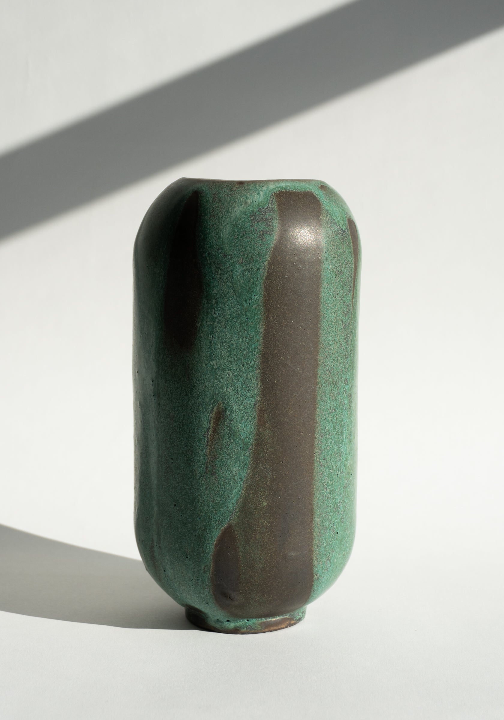 Mondays Ceramics Cylinder Vase in Green Patina on Umber
